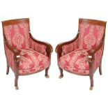 A Pair of Empire Period Mahogany Chairs: With scroll arms and on cloven hoof legs,