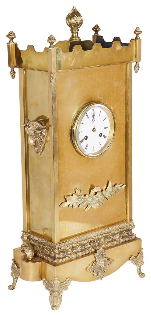 A 19th Century French Brass Mantel Clock: With stepped form top and floral finials and large flame