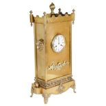 A 19th Century French Brass Mantel Clock: With stepped form top and floral finials and large flame
