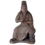 A Soft Wood Ching Dynasty Carved Warrior: In a seated pose stroking his beard and reading a book,