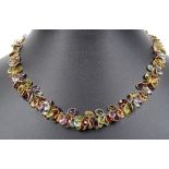 A 14ct Multi-stone Necklace: Set with oval cut semi precious stones throughout, on s link clasp.