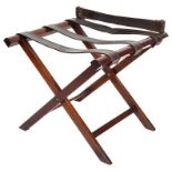 A Luggage Stand: Of cantilever construction in mahogany with leather strap work and lip to the back.