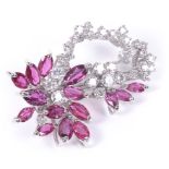 An 18ct White Gold Ruby and Diamond Flower Brooch: Set with marquise cut rubies as the leaves and