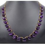 An 18ct Cabochon Amethyst Necklace: Comprising 21 graduated claw set amethysts