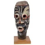 An African Tribal Painted Carved Head: Painted in black, red and white,