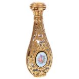 A French Gold Enamelled Perfume Bottle: Crystal bottle encased in hinged gold filigree floral