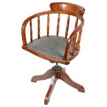 An Edwardian Oak Captain's Chair: Nine turned spindle back with padded seat,