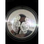 A silver-cased commemorative coin,