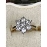 An 18ct diamond daisy ring