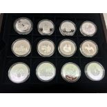 A cased Queen Mother Commonwealth set of 24 silver coins