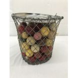 A basket of approximately 100 antique snooker balls (no ivory examples)