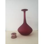 A red glass trumpet-shaped vase;