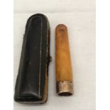 A gold-rimmed amber-cased Victorian cheroot holder