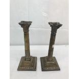 A pair of HM silver Corinthian candlesticks