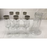 Six glasses and a vase