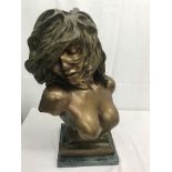 A bronze bust of a semi-nude lady