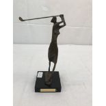 A bronze stylistic figure of a lady golfer