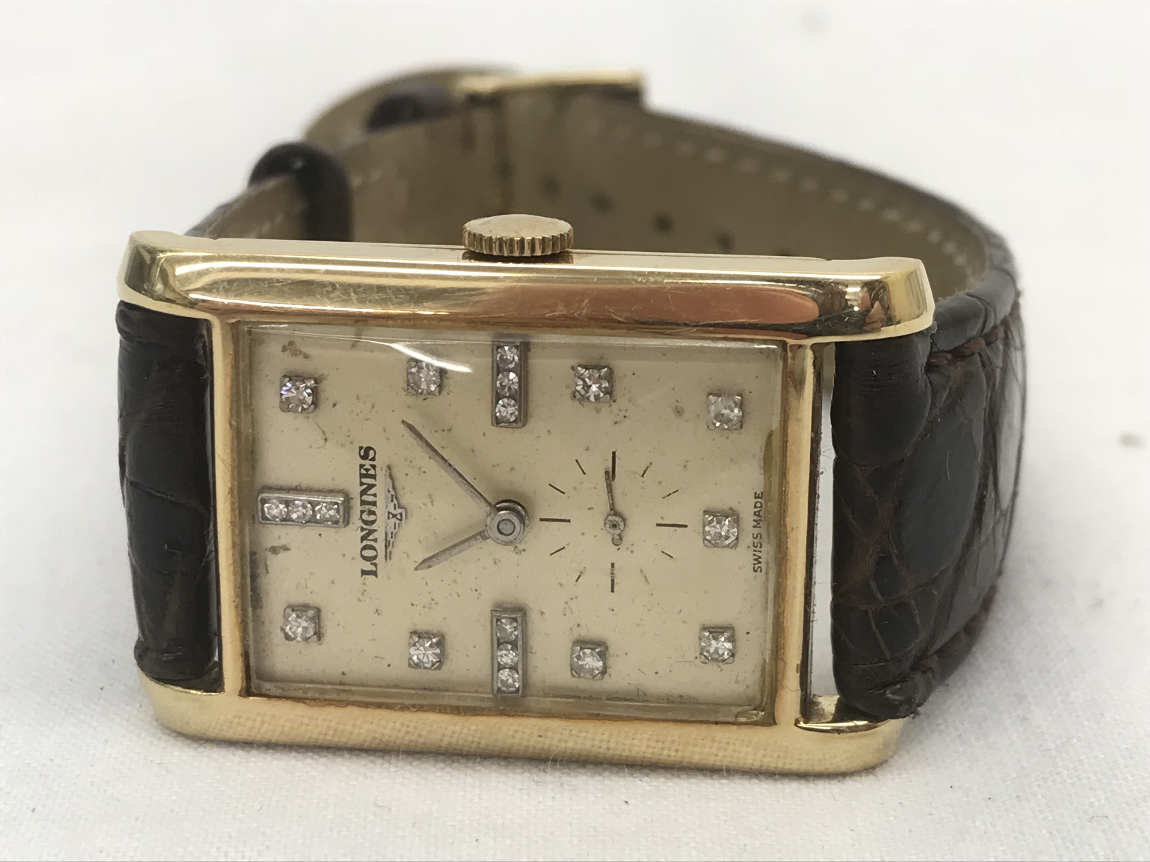A 14k 1940s Longines square-cased gentleman's wristwatch CONDITION REPORT: The watch