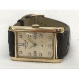 A 14k 1940s Longines square-cased gentleman's wristwatch CONDITION REPORT: The watch