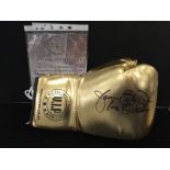 A gold boxing glove signed by World Heavyweight champion James Buster Douglas with CoA