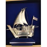 A sterling silver galleon enclosed in a frame