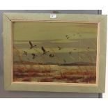 An oil on board depicting flying ducks, signed lower right,