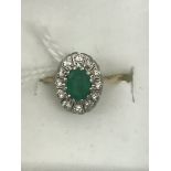 An 18ct emerald and diamond dress ring