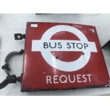 A double-sided enamel bus stop 'Request' sign