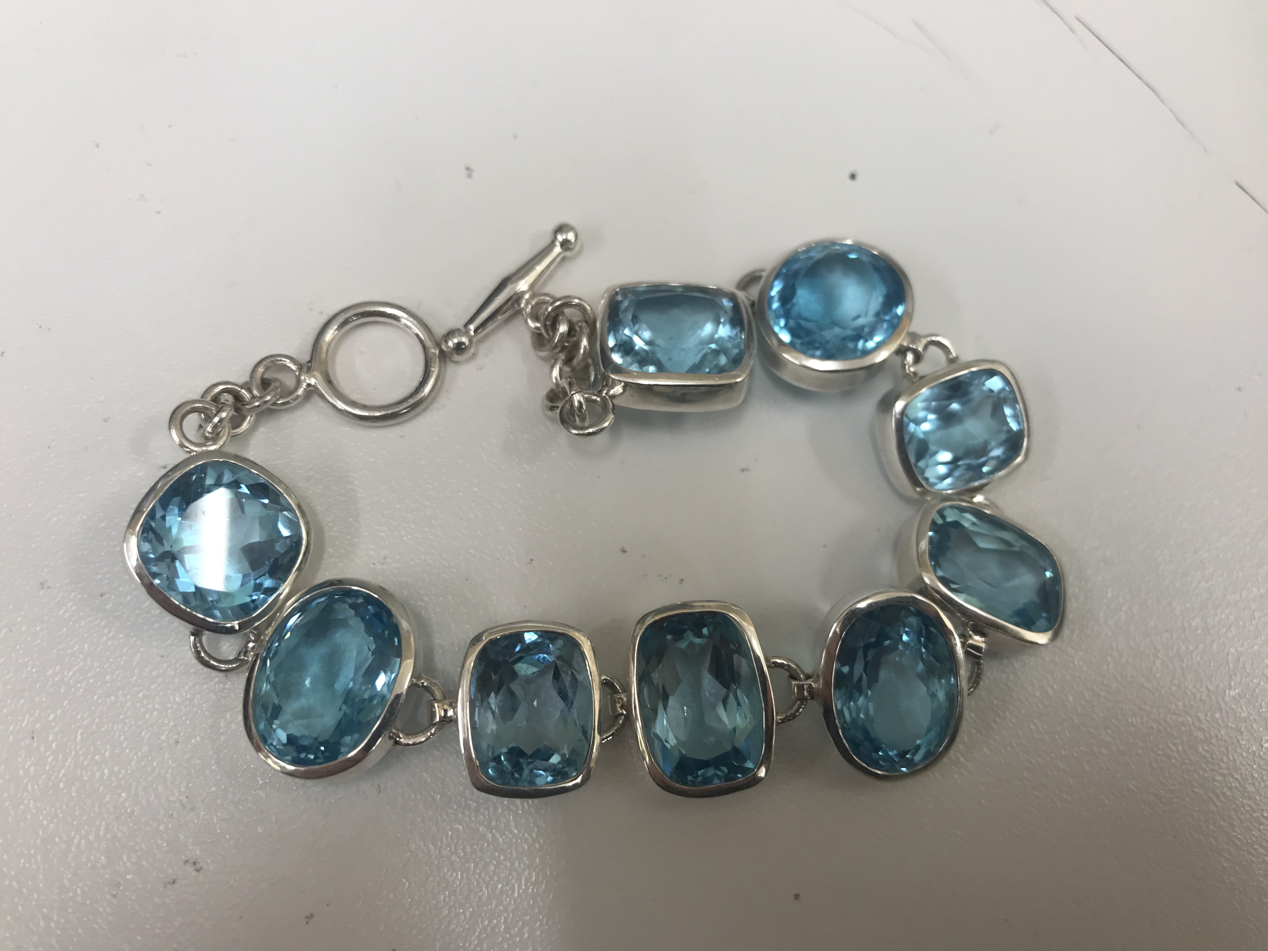 A silver and blue topaz bracelet