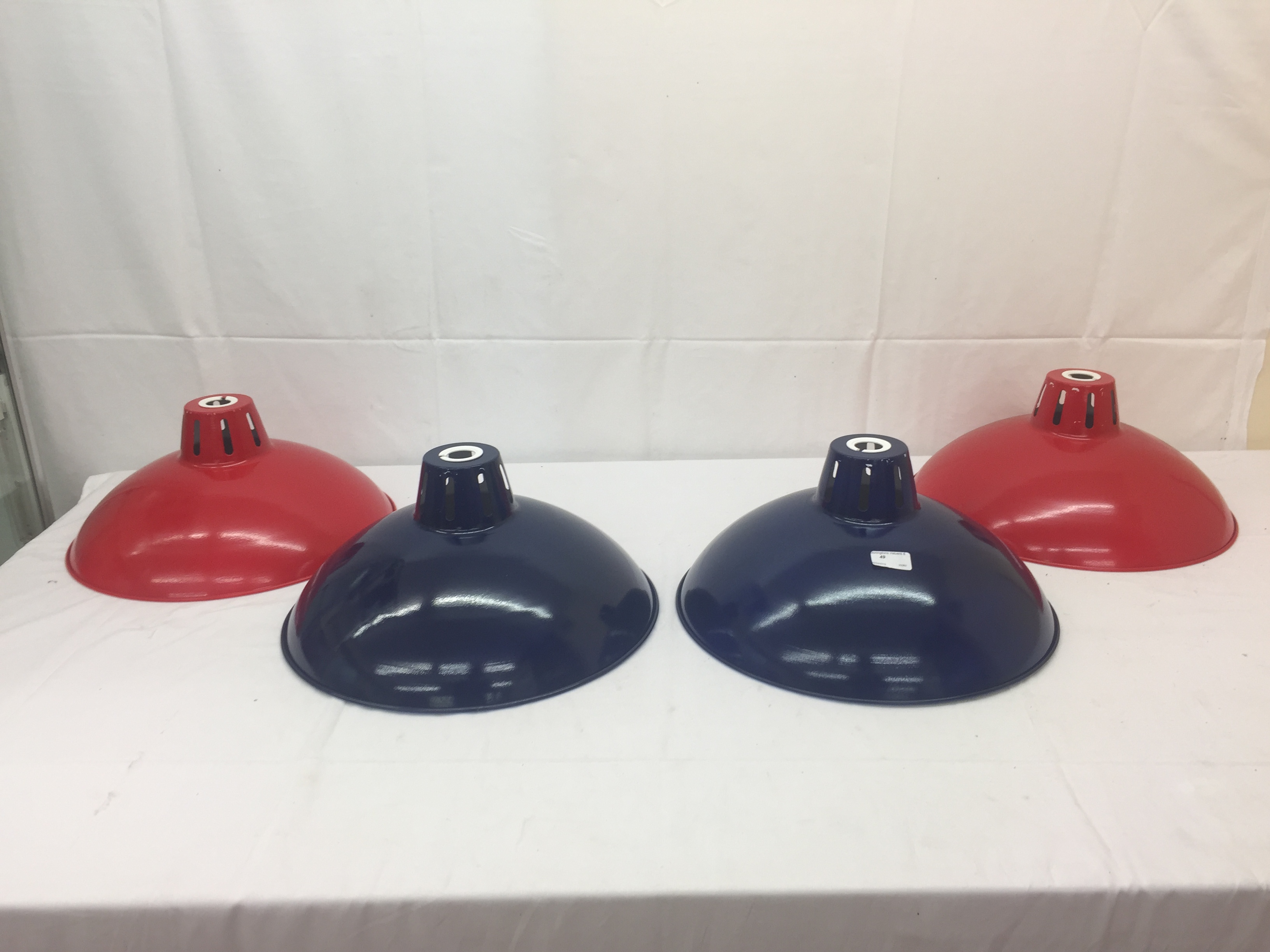 Four industrial metal and enamel pendant lamp shades: red and blue