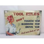 A tin sign: 'Tool Rules'