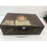 A 1920s crocodile suitcase with travel labels to Karachi