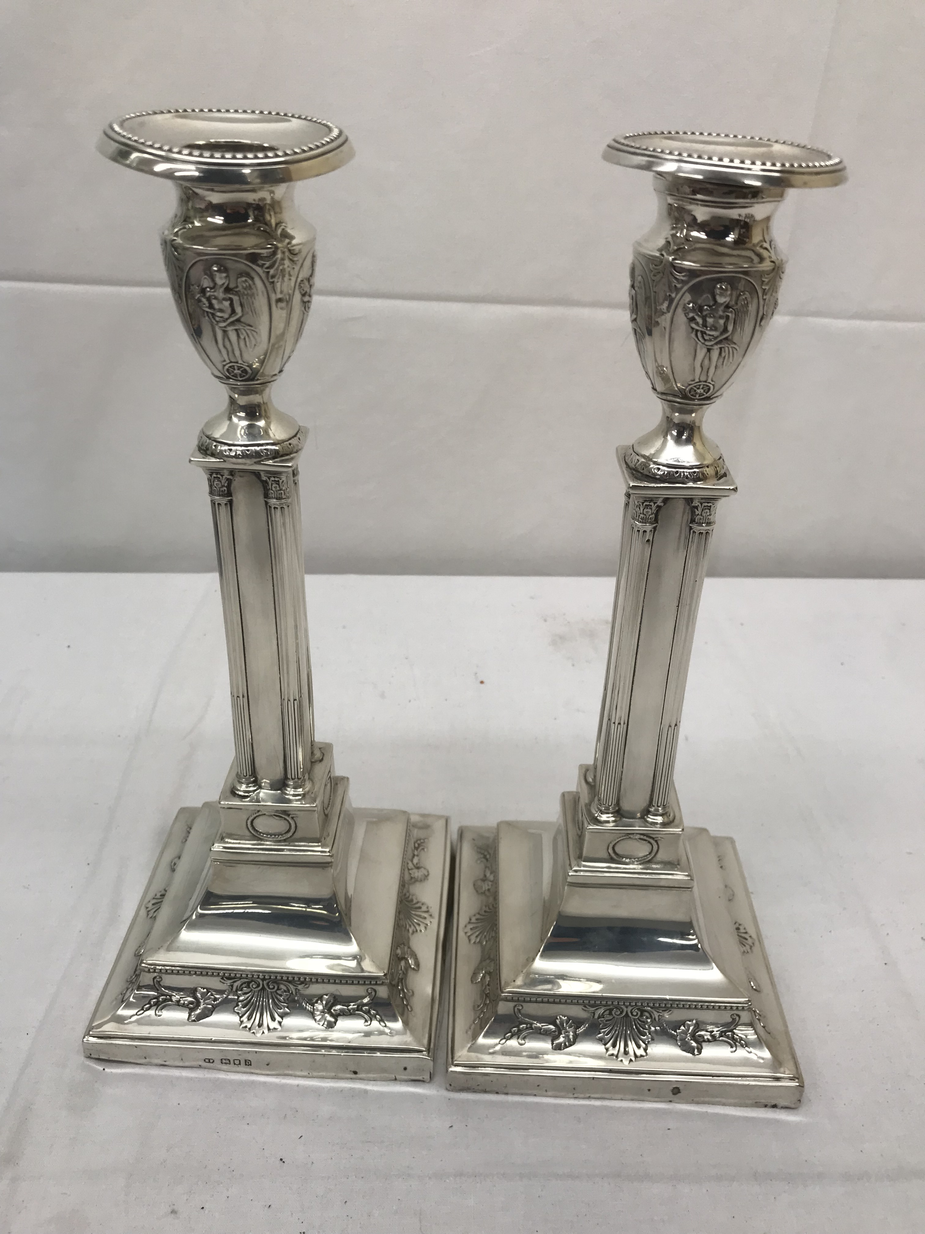 A pair of HM silver candlesticks