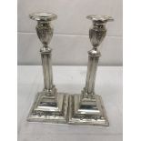 A pair of HM silver candlesticks