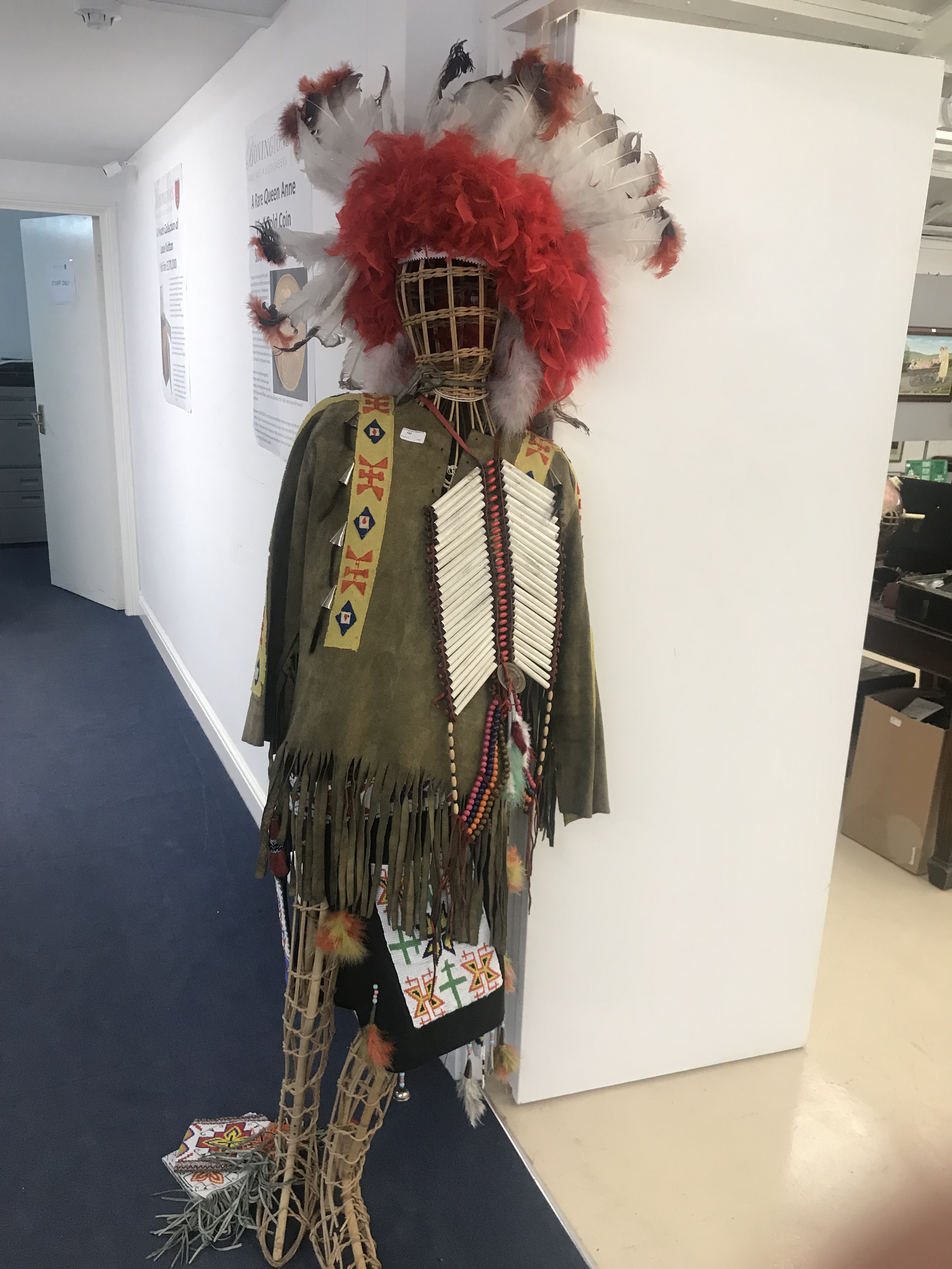 A Red Indian costume on a wicker mannequin
