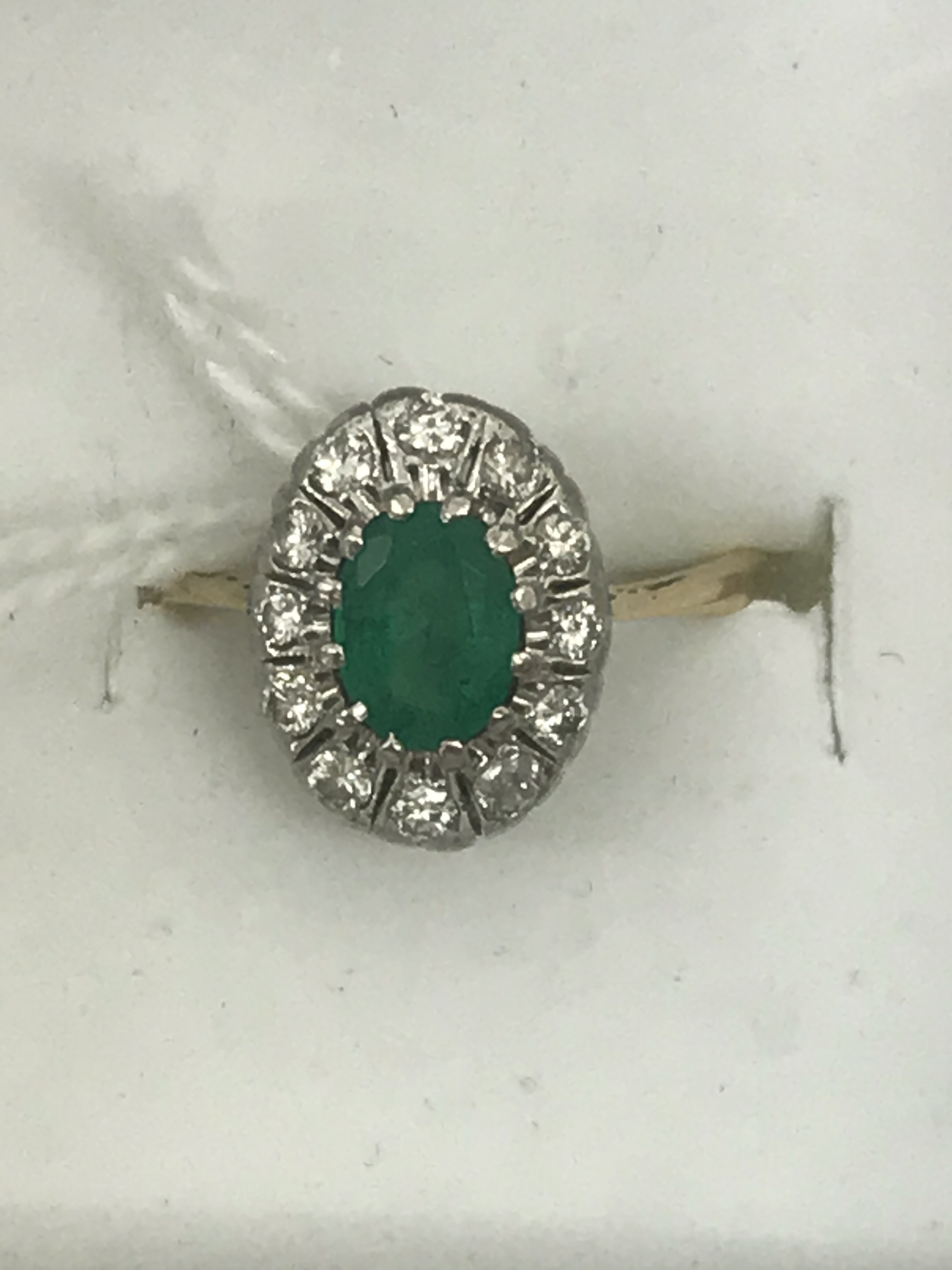 An 18ct emerald and diamond dress ring