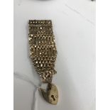 A 9ct bracelet with heart locket