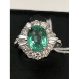 A 3ct emerald ring set with 1.
