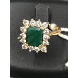 An 18ct diamond and emerald ring