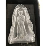 A glass sculpture of a saint