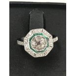 A 0.85ct Art Deco diamond and emerald ring set in 18ct white gold