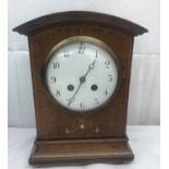 An inlaid oak mantel clock