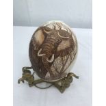 An ostrich egg with elephant carving