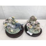 A pair of Lladro figures of a boy and girl sitting amongst flowers