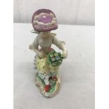 A 19th century Meissen figure of a lady holding a basket of flowers;