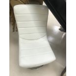 An Ercol cream leather and chrome chair