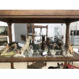 A shelf of german shepherd figures