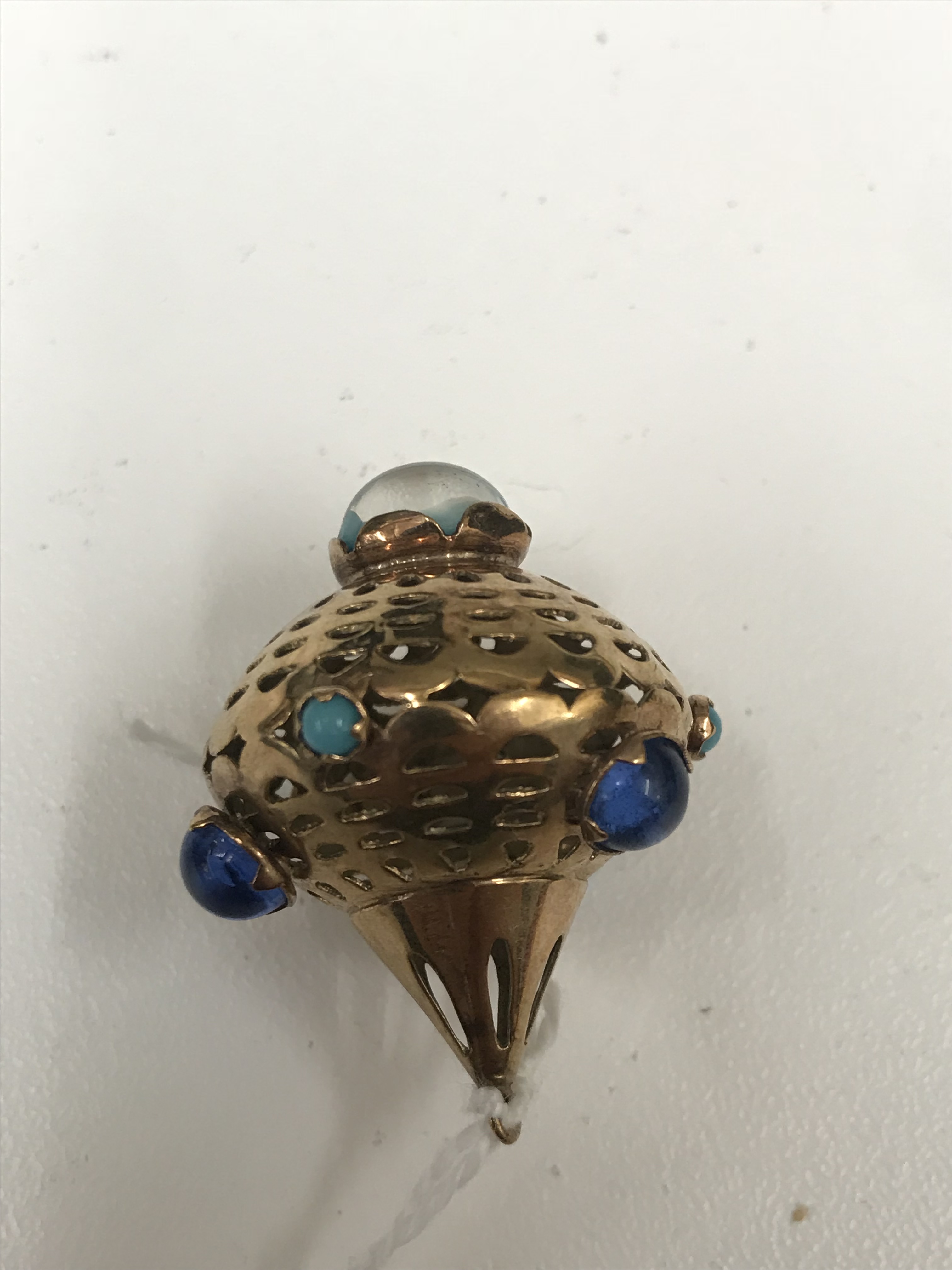 A gold and cabochon blue stone pendant