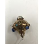 A gold and cabochon blue stone pendant