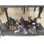 A shelf of german shepherd figures